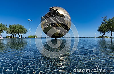 PESARO, ITALY - 21 AUGUST 2020: Grande Sphere by Arnaldo Pomodoro reflected in the water in Piazza della LibertÃ  in Pesaro Editorial Stock Photo